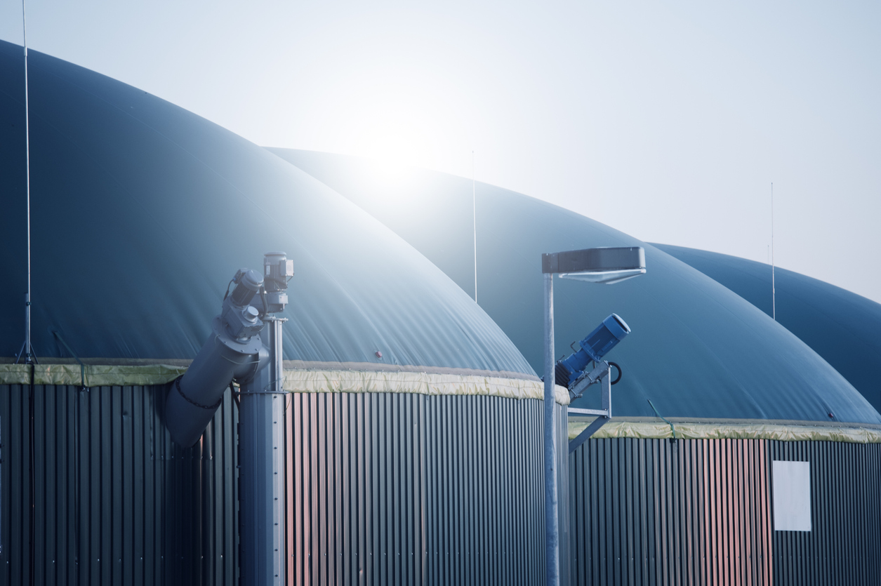 a large round metal structures with a blue cover - Biogas and Renewable Natural Gas Law