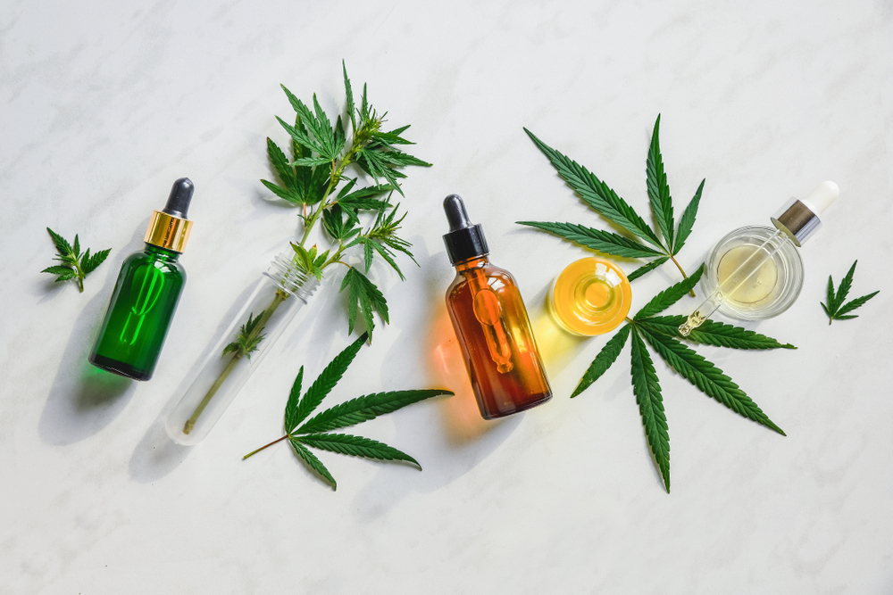 a group of bottles with a dropper and leaves - Navigating Cannabis Legalization in Minnesota: Updating Your Workplace Drug Testing Policies 