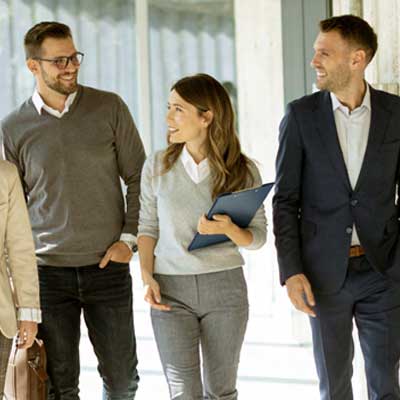 A group of people walking in a hallway - Mapping Out Your Transition Journey