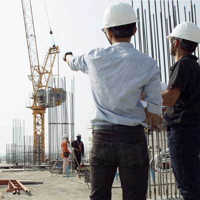 A few men in hard hats at a construction site - Ensuring Operational Stability and Mitigating Risks