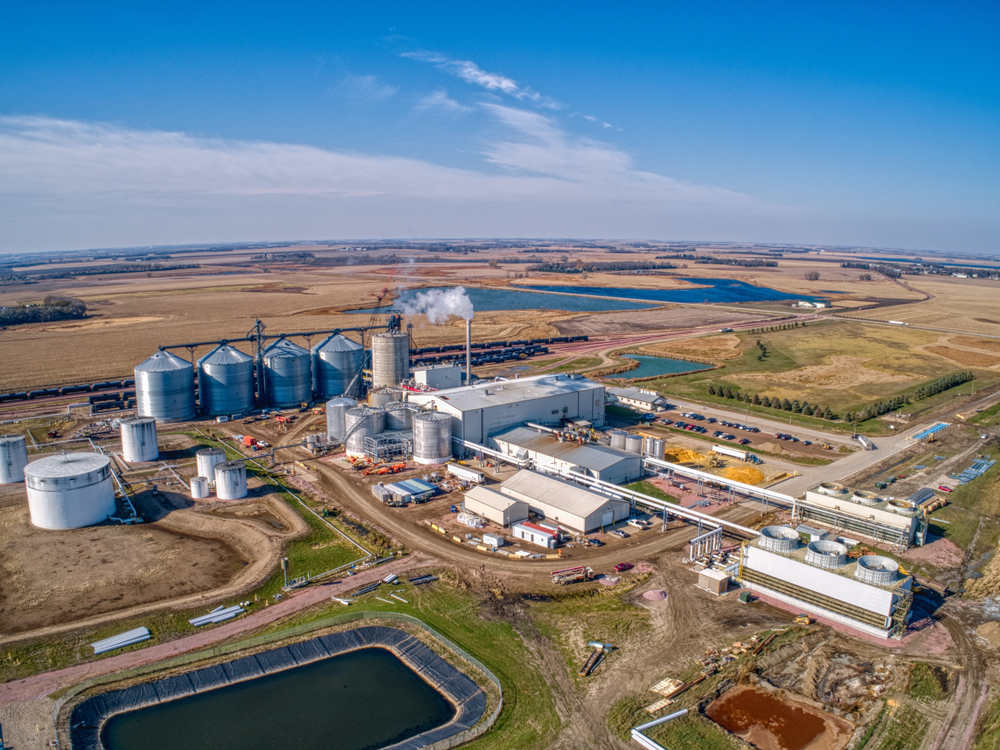 a factory with several silos and a water reservoir - Solar Energy